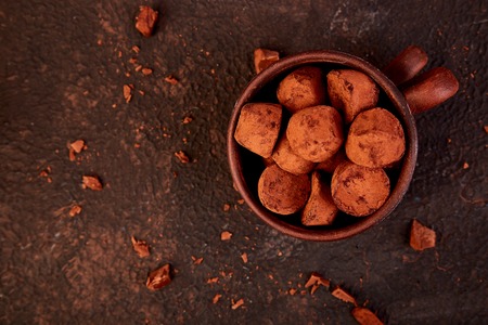 Chocolate Candy truffles in brown plate. Copy space, Dessert. Cocoa candies.  delicious. tasty
