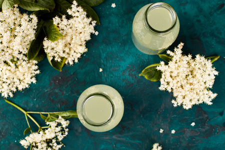 Kombucha tea with elderflower on green background. Homemade fermented infused drink. Summer Healthy natural probiotic flavored drink. Top view.の写真素材