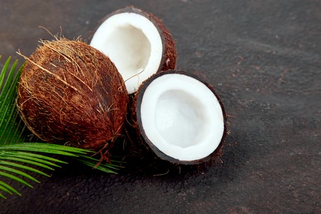 Fresh Coconut on brown background. Flat lay. Copy space, Food concept. Still lifeの写真素材