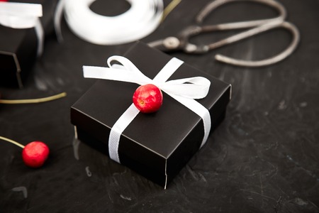 Wrapping modern Christmas or Birthday gifts presents. Gift boxes in Black and White color. Flat lay, top view. Scissorsの写真素材