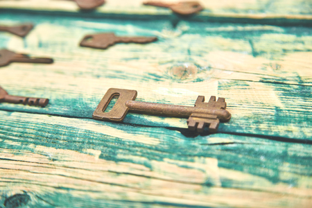 Collection of many different old retro keys in order on wooden rustic background concept. Creative...