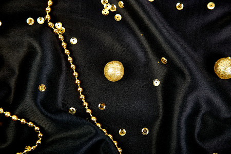 Luxury black background with gold  shiny balls. Christmas, birthday party. Flat lay. Copy space. Top...