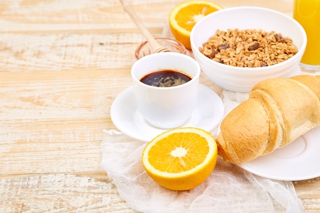 Good morning.Continental breakfast on ristic wooden background. Cup of coffee, orange juice,...