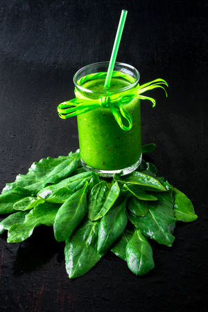 Spinach smoothie. Blended green smoothie with ingredients on black table. Healthy , vegan, diet. Detoxの写真素材