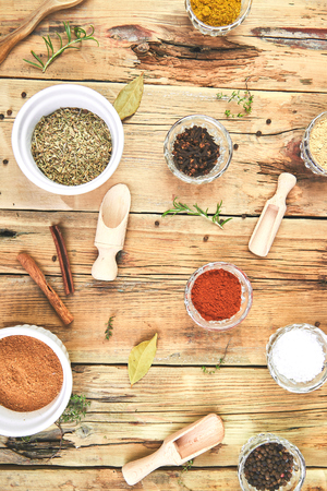 Flat lay of Seasoning background. Spice and herb seasoning with fresh and dried herbs and spices in bowls. Colourful various herbs and spices for cooking on wooden rustic background. Top view.の写真素材
