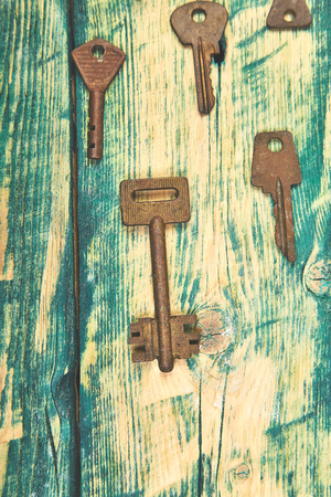 Collection of many different old retro keys in order on wooden rustic background concept. Creative decorative background. Flat lay. Copy space. Top view.の写真素材