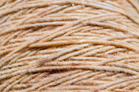 Thread in clew close up picture. Close up of light burlap texture background. Twine. Top view. Copy space.の写真素材