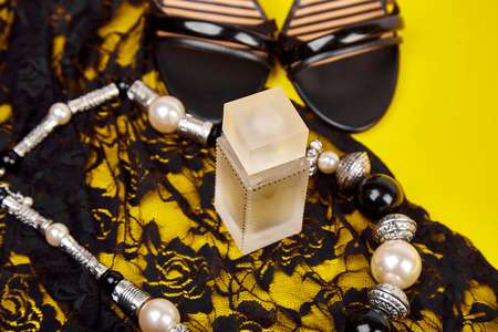 Fashion feminine blogger concept. Minimal set of women accessories yellow background.