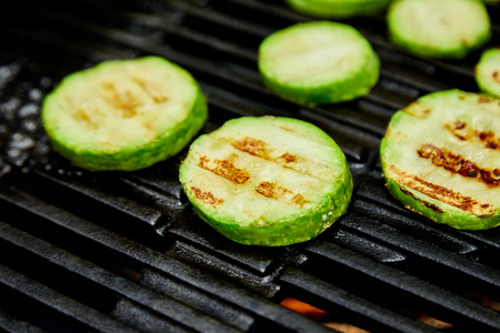Grilled zucchini vegetable on huge gas grill . Vegan food. Diet, healthy Picnic. Summer. Top view. Flat lay. Copy space.の写真素材