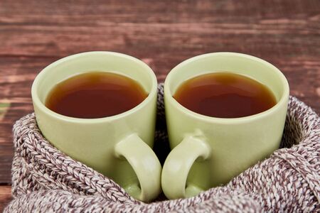Two warm cups of tea, autumn leaves on wooden table. Autumn. Fall season. Still life. Flat lay. Top view.の写真素材