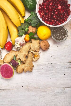 Products rich in antioxidants and vitamins, mineral on white wooden background, Healthy diet, vegan food. Top view, flat lay, copy space.の写真素材