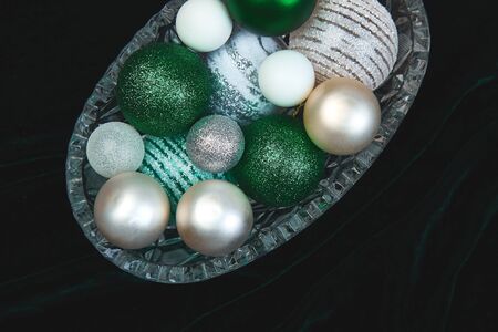 Christmas or New Year preparations. Flat lay of green, white and silver Christmas tree decoration...