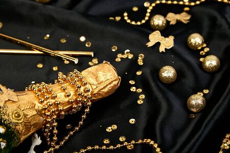 Gold Champagne bottle with confetti stars and party streamersの写真素材