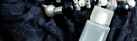 Banner of Women outfit. Evening accessory for party. necklace and perfume on black lace dress background.の写真素材