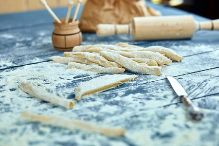 Closeup process making homemade pasta. Fresh dough for italian traditional pasta to thin ribbon. Italian cuisine recipe. Home cuisine.の写真素材
