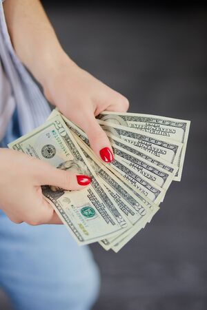 Woman hold money dollars in hand. Concept of happiness, success.