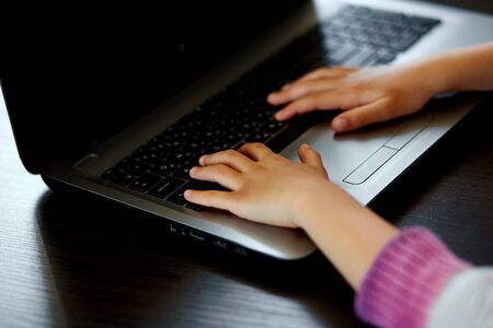 Close up of girls hand with notebook, Schoolgirl studying at home with a notebook and doing school...