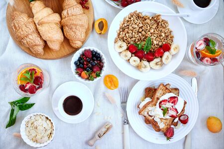 Fresh and bright continental breakfast table, abundance healthy meal variety crunch cereal, french...