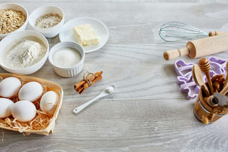 Homemade production of fresh healthy cookies from natural ingredients on a light grey background,...