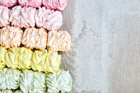 Sweet homemade marshmallow, background from multicolor pastel zephyr, top view, copy space. Flat lay.の写真素材
