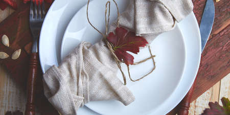 Banner of Fall table setting for Thanksgiving day celebration on wooden background. Autumn table setting. Top view. Falt lay. Copy space.の写真素材