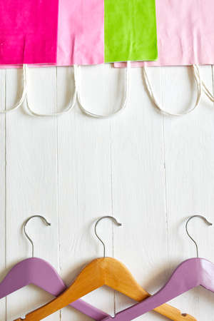 Colorful Pink, green paper shopping bag, with hangers on white backgroundの写真素材