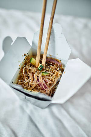 Tasty Udon noodles pasta with tempuru, shrimps wok in box deliveryの写真素材
