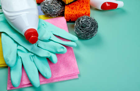Flat lay of variety house cleaning product on blue table with copy space, cleaning set for different surfaces, Detergents service concept, Top view.の写真素材