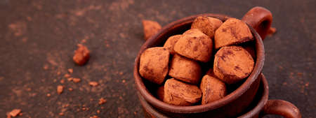 Banner of Chocolate Candy truffles in brown plate. Copy space, Dessert. Cocoa candies. delicious....
