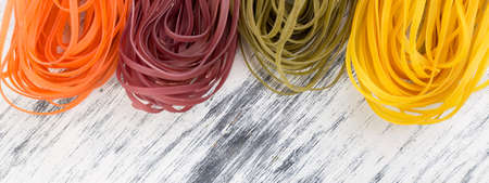Banner of Colored Raw Vegetable Vegetarian Pasta with Beets, Carrots and Spinach. Flat lay. Copy space. Top view. Frame.の写真素材