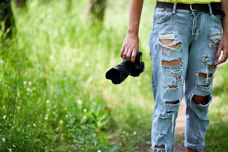 Woman photographer with a photo camera in hand outdoor, World photographer day, creative hobby, copy space, place for text, Photography Concepts Professional.の写真素材