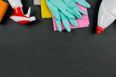 Flat lay of variety house cleaning product on black table with copy space, cleaning set for...