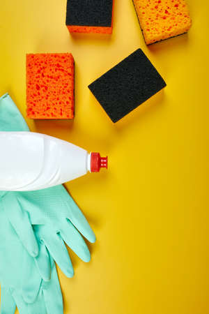 Flat lay of cleaning set for dish washing yellow background with copy space, Detergents service concept, Top view.の写真素材