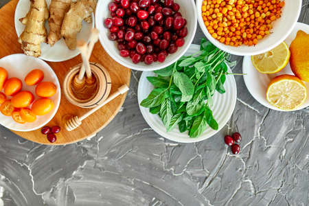 Trendy Virus protection food, immunity concept. Assortment product of rich in antioxidants and vitamins sources on grey background, Healthy food nutrition dieting concept.の写真素材