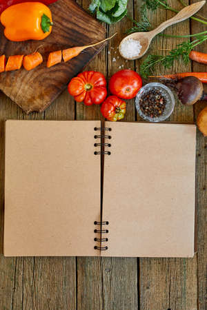 Flat lay of ingredient of cooking, vegetables around recipe book, grocering, local food, healthy clean eating, Vegetarian and vegan food, diet spring concept, top view, copy space.の写真素材