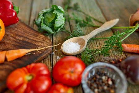 Flat lay of various organic vegetables ingredients and spicy on wooden background, local food, Vegetarian and vegan food, diet spring concept, top view, copy space.の写真素材