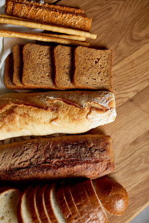 Top view of various kinds of bread on a wooden surface. Close up Concept of homemade bread, small...