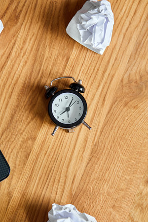 Top view of wooden office desk with clock, crumpled paper balls, Change Your Mindset, plan B, time to set new goals, plans, Time management concept, flat lay.の写真素材