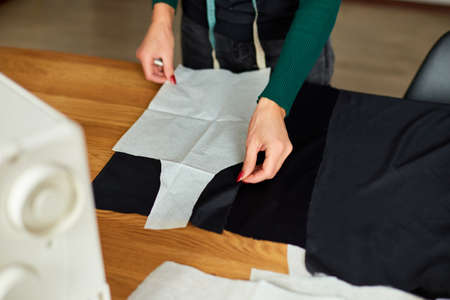 Step by step, Woman dressmaker female making sewing patterns, Mature tailor working with sewing pattern in atelier, textile industry, hobby, workspace. Creation process DIY, Workplace of seamstress.の写真素材