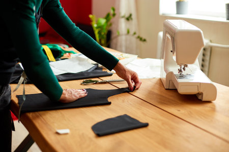 Step by step, woman dressmaker female measuring sewing pattern On Table, Mature tailor working in atelier, textile industry, hobby, workspace. Creation process DIY, Workplace of seamstress.の写真素材