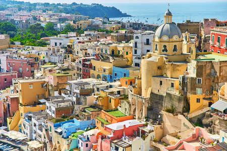 Small boats in port on a Bay of Procida island, Naples, Italy, colorful houses in Marina di Corricella Daylight view of beautiful Procida in sunny summer dayの写真素材