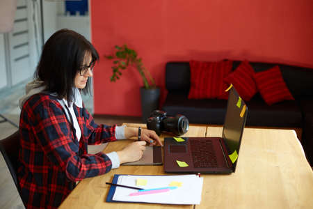 Big ostriches at farm field behind a wooden fence, Domestic animals outdoors, Ecological farming concept.の写真素材