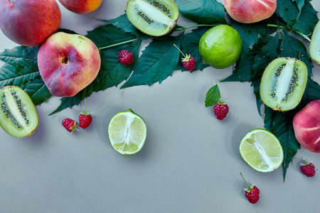 Summer background flat lay Fruits peach, kiwi, raspberry, lime on grey paper, Trendy shadow and...