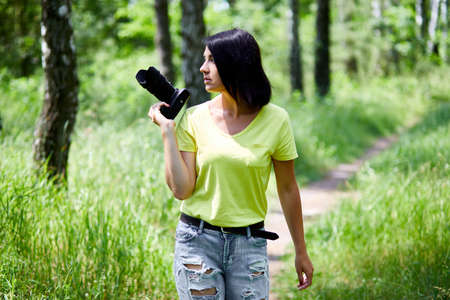 Woman photographer with a photo camera in hand outdoor, World photographer day.