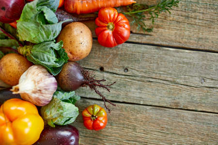 Flat lay of assortment of fresh vegetables, bio healthy, organic food on wooden background, country...