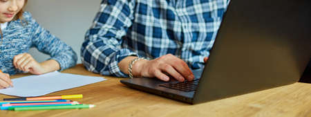 Banner of Father working in his home office on a laptop, her daughter sits next to her and draw, Man...