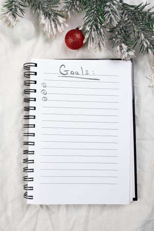 Top view of blank notebook for goals resolutions and christmas decoration
