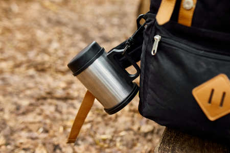 Travel backpack with accessory on autumn background, local travel, mental health. Copy spaceの写真素材