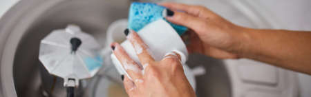 Banner Unrecognizable woman housewife washing dishes in the kitchen at home over sinkの写真素材