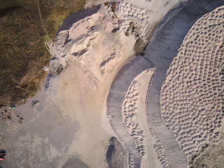 Aerial view of Slope operating granite quarry with mining equipment on ledges, Industrial quarry,...